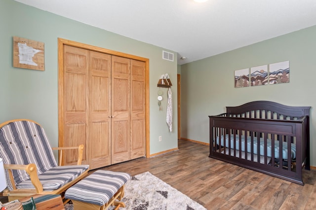 8475 121st Ave N, Champlin, MN 55316 - bedroom with wood finished floors and a closet