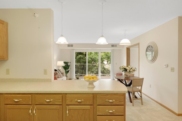 5650 Boone Ave N, New Hope, MN 55428 - kitchen featuring light colored carpet, light countertops, a peninsula, and pendant lighting