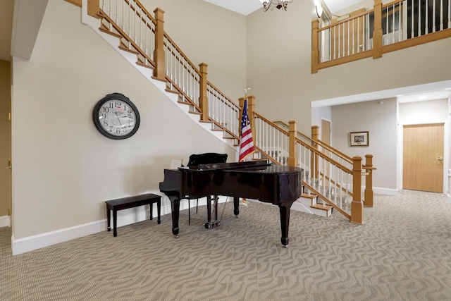 5650 Boone Ave N, New Hope, MN 55428 - sitting room featuring carpet, a high ceiling, stairs, baseboards, and a chandelier