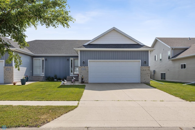 3364 27th St S, Moorhead, MN 56560 - view of front of home with brick siding, an attached garage, a shingled roof, and a front yard