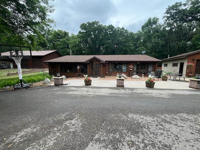 5940 150th Ave NE, New London Twp, MN 56288 - back of property featuring log siding