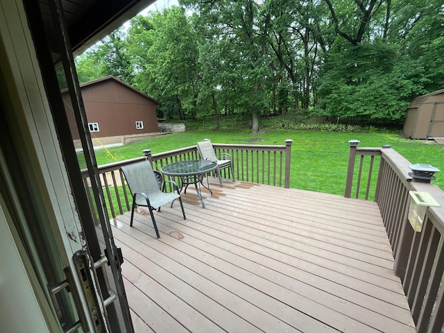 5940 150th Ave NE, New London Twp, MN 56288 - wooden deck featuring a yard, a storage shed, and view of scattered trees