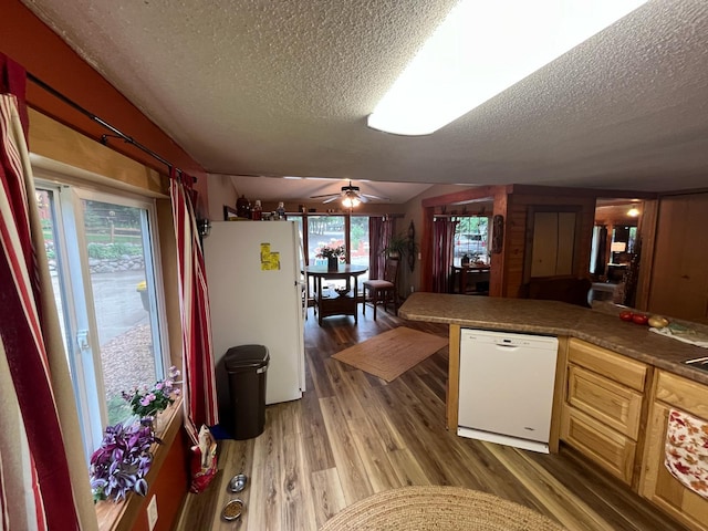 5940 150th Ave NE, New London Twp, MN 56288 - kitchen with white appliances, a textured ceiling, light wood-type flooring, ceiling fan, and lofted ceiling