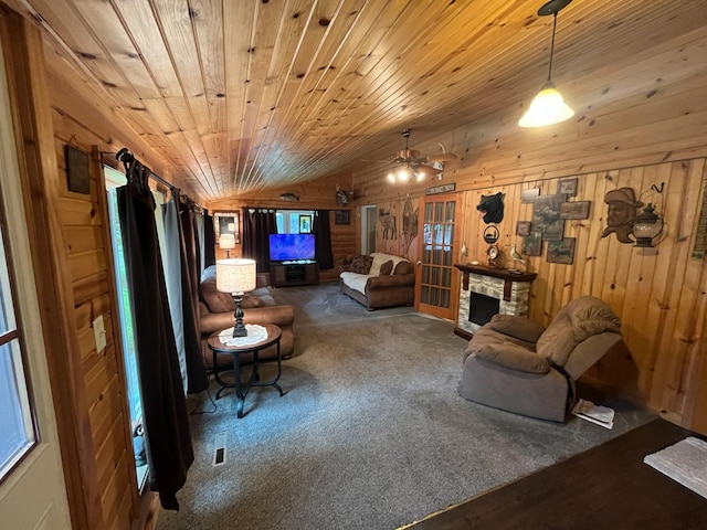 5940 150th Ave NE, New London Twp, MN 56288 - carpeted living area with lofted ceiling, wooden walls, a stone fireplace, a ceiling fan, and wood ceiling