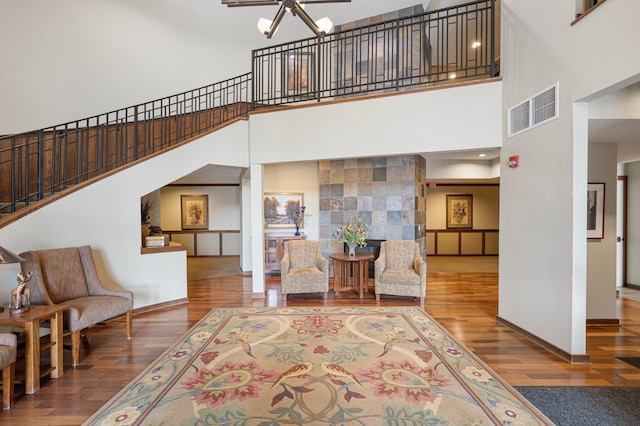 9165 Comstock Ln N Unit 106, Maple Grove, MN 55311 - living room with a towering ceiling, wood finished floors, ceiling fan, and stairway