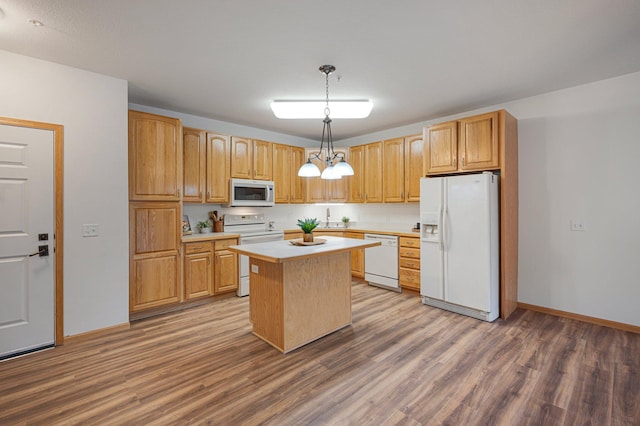 9165 Comstock Ln N Unit 106, Maple Grove, MN 55311 - kitchen featuring white appliances, light countertops, wood finished floors, a center island, and pendant lighting