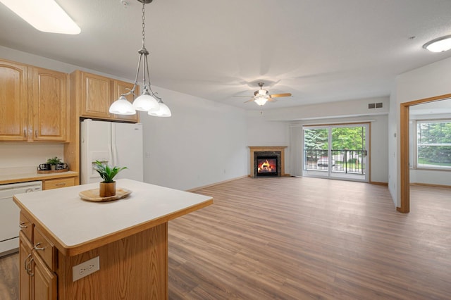 9165 Comstock Ln N Unit 106, Maple Grove, MN 55311 - kitchen featuring white appliances, wood finished floors, ceiling fan, light countertops, and a kitchen island