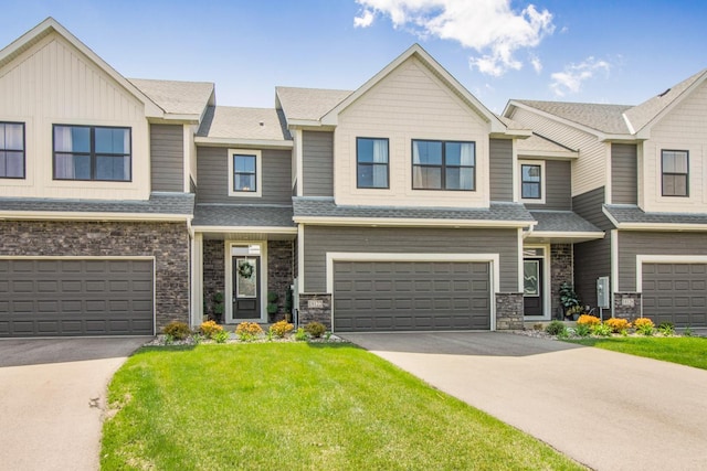 18122 Garland Path, Lakeville, MN 55044 - multi unit property with a garage, driveway, stone siding, a front yard, and a shingled roof