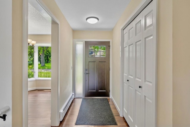 101 Sunset Dr S, Minnetonka, MN 55305 - entrance foyer with a baseboard heating unit and wood finished floors