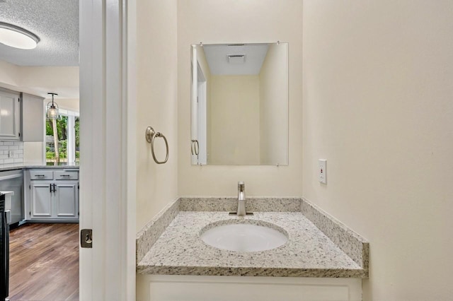 101 Sunset Dr S, Minnetonka, MN 55305 - bathroom with vanity, wood finished floors, and backsplash