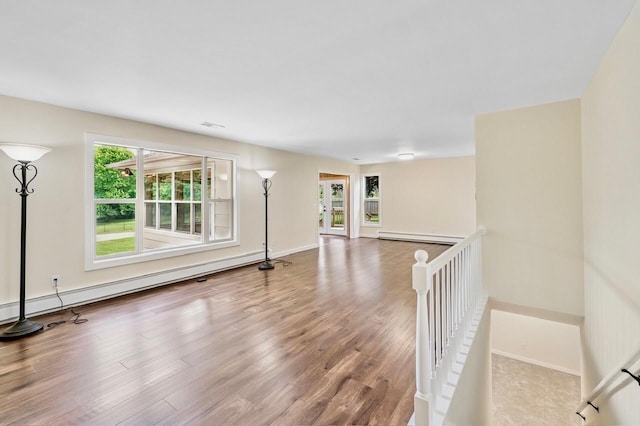 101 Sunset Dr S, Minnetonka, MN 55305 - unfurnished room featuring wood finished floors and a baseboard heating unit