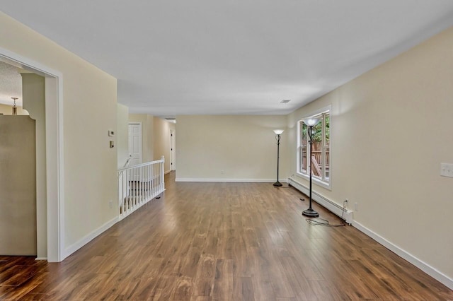101 Sunset Dr S, Minnetonka, MN 55305 - spare room with a baseboard heating unit and wood finished floors