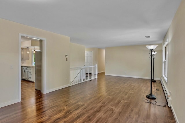 101 Sunset Dr S, Minnetonka, MN 55305 - spare room featuring dark wood finished floors and baseboard heating