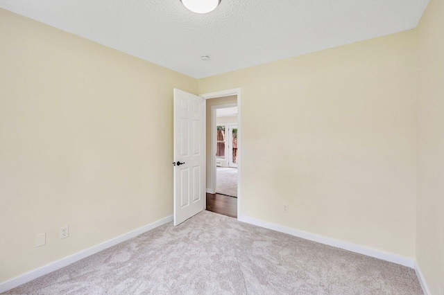 101 Sunset Dr S, Minnetonka, MN 55305 - carpeted spare room featuring baseboards and a textured ceiling