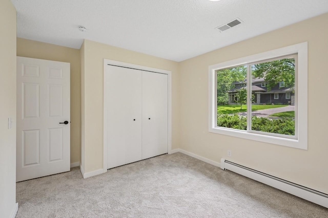 101 Sunset Dr S, Minnetonka, MN 55305 - unfurnished bedroom featuring a baseboard radiator, carpet floors, and a closet