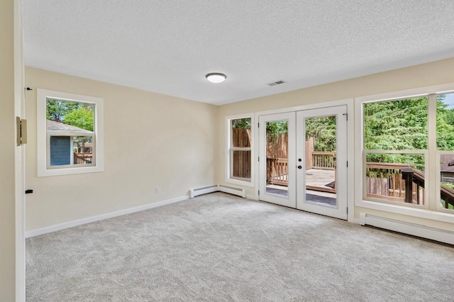 101 Sunset Dr S, Minnetonka, MN 55305 - empty room with carpet flooring, french doors, a textured ceiling, and a baseboard heating unit