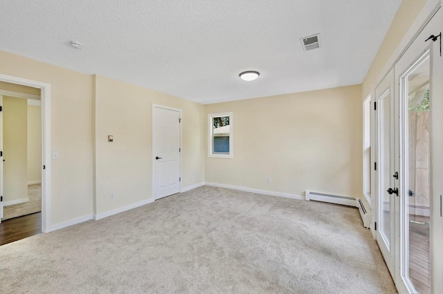 101 Sunset Dr S, Minnetonka, MN 55305 - unfurnished bedroom with carpet flooring, a baseboard heating unit, and a textured ceiling
