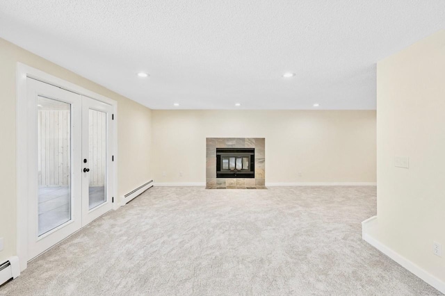 101 Sunset Dr S, Minnetonka, MN 55305 - unfurnished living room with a baseboard radiator, carpet floors, recessed lighting, a textured ceiling, and french doors