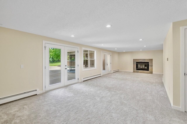 101 Sunset Dr S, Minnetonka, MN 55305 - unfurnished living room with baseboard heating, carpet flooring, french doors, a tiled fireplace, and recessed lighting