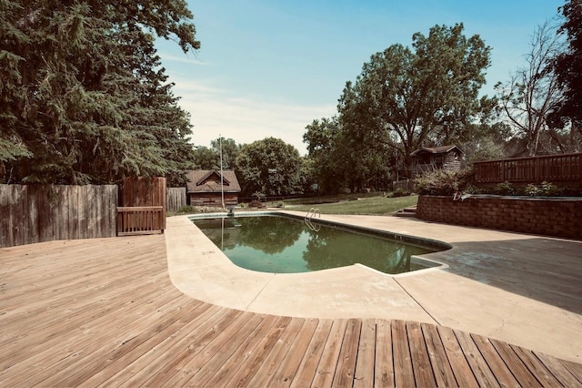 101 Sunset Dr S, Minnetonka, MN 55305 - view of swimming pool featuring a fenced backyard, a patio, a storage shed, and a deck