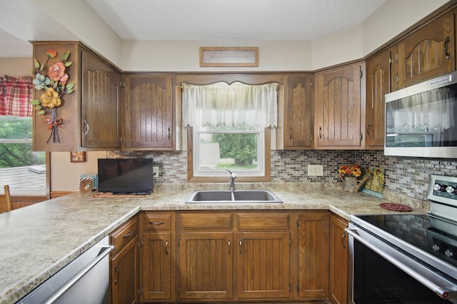 20128 554th St, Concord Twp, MN 55985 - kitchen featuring appliances with stainless steel finishes, light countertops, decorative backsplash, and a textured ceiling