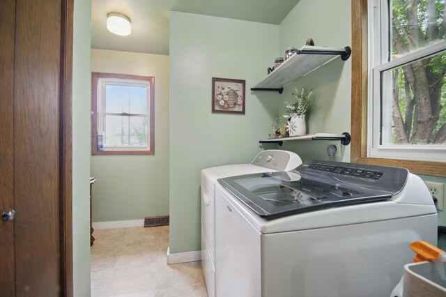 20128 554th St, Concord Twp, MN 55985 - laundry area with washing machine and dryer and light tile patterned floors