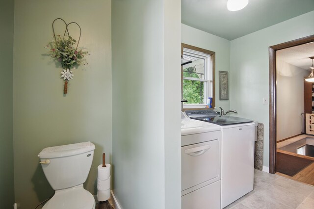20128 554th St, Concord Twp, MN 55985 - laundry area with washing machine and dryer and light tile patterned floors