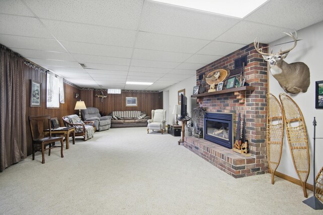 20128 554th St, Concord Twp, MN 55985 - carpeted living area featuring a drop ceiling, wood walls, and a fireplace