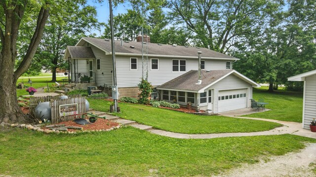 20128 554th St, Concord Twp, MN 55985 - back of property with a chimney, a lawn, driveway, and a shingled roof