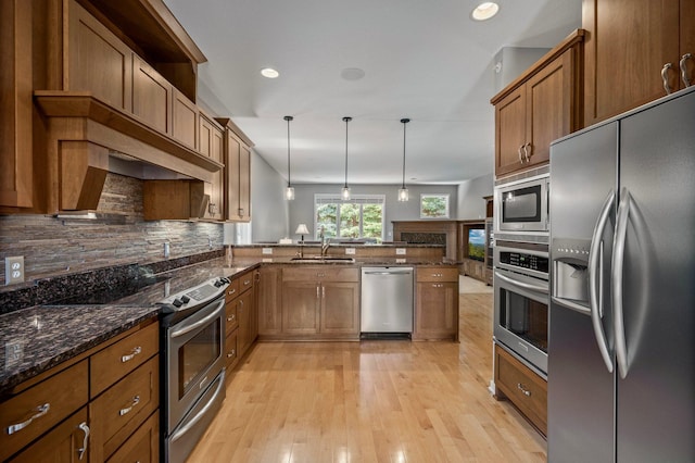 17365 Hanson Ct, Eden Prairie, MN 55347 - kitchen featuring stainless steel appliances, brown cabinets, a peninsula, pendant lighting, and tasteful backsplash