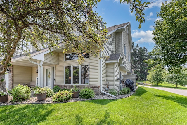 4426 Lakeshore Ter, Eagan, MN 55122 - view of front of property featuring a front lawn and a shingled roof