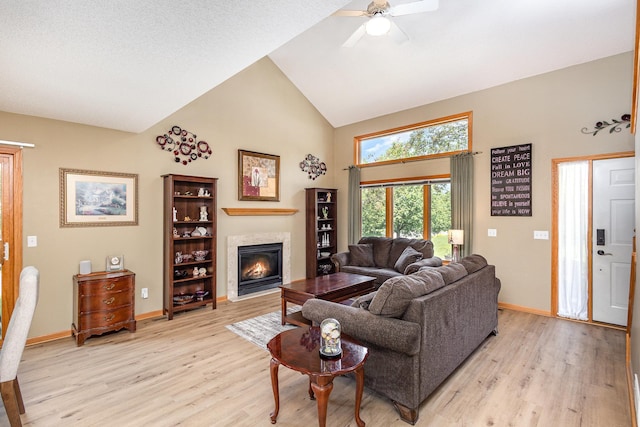 4426 Lakeshore Ter, Eagan, MN 55122 - living area featuring high vaulted ceiling, light wood finished floors, a glass covered fireplace, and a ceiling fan
