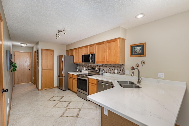 4426 Lakeshore Ter, Eagan, MN 55122 - kitchen featuring stainless steel appliances, a peninsula, decorative backsplash, light stone counters, and a textured ceiling