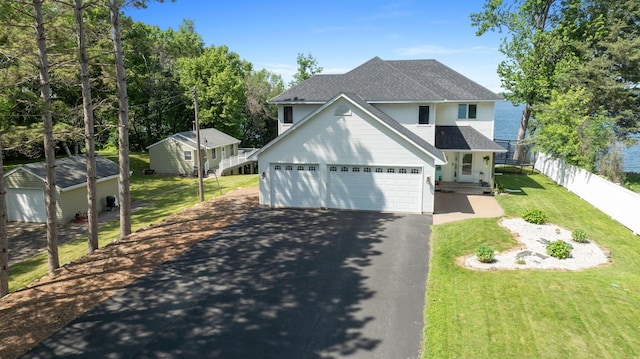 10460 Kismet Isle, Chisago Lake Twp, MN 55013 - traditional home featuring asphalt driveway, roof with shingles, and a garage