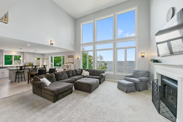 10460 Kismet Isle, Chisago Lake Twp, MN 55013 - living room with a high ceiling, light carpet, a fireplace, and recessed lighting