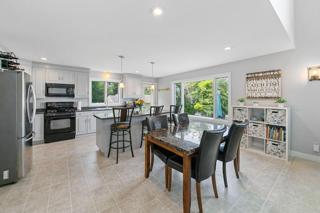 10460 Kismet Isle, Chisago Lake Twp, MN 55013 - dining space featuring recessed lighting, plenty of natural light, and light tile patterned floors