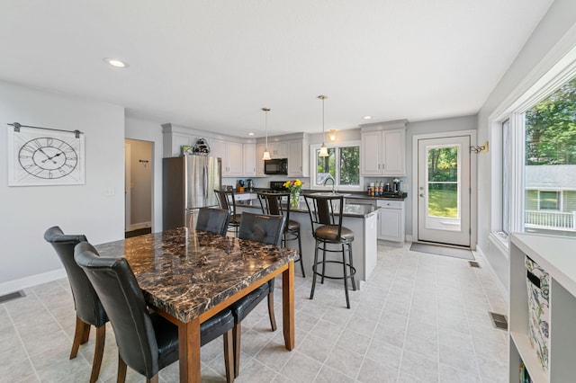 10460 Kismet Isle, Chisago Lake Twp, MN 55013 - dining room with recessed lighting and light tile patterned floors