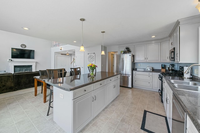 10460 Kismet Isle, Chisago Lake Twp, MN 55013 - kitchen featuring appliances with stainless steel finishes, recessed lighting, a center island, a glass covered fireplace, and open floor plan