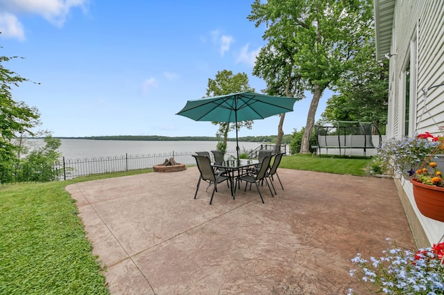 10460 Kismet Isle, Chisago Lake Twp, MN 55013 - view of patio featuring a trampoline, a water view, and outdoor dining space