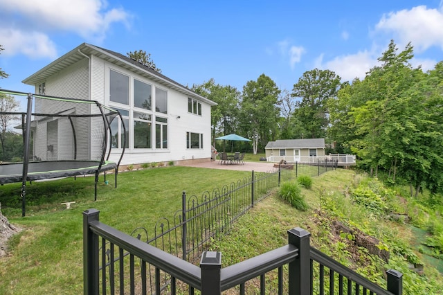 10460 Kismet Isle, Chisago Lake Twp, MN 55013 - fenced yard featuring a trampoline and a patio