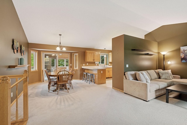 22087 Jasmine Way, Rogers, MN 55374 - living room with light colored carpet, vaulted ceiling, and a chandelier