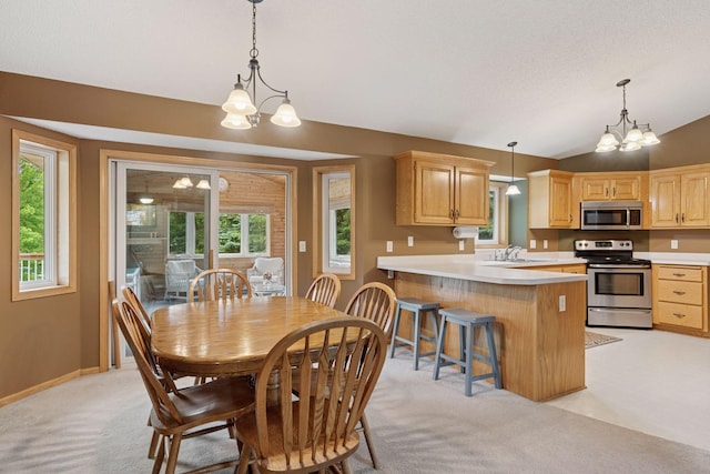 22087 Jasmine Way, Rogers, MN 55374 - dining area with a chandelier, vaulted ceiling, and light colored carpet