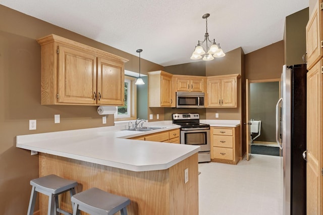 22087 Jasmine Way, Rogers, MN 55374 - kitchen featuring appliances with stainless steel finishes, a peninsula, a breakfast bar area, vaulted ceiling, and light countertops