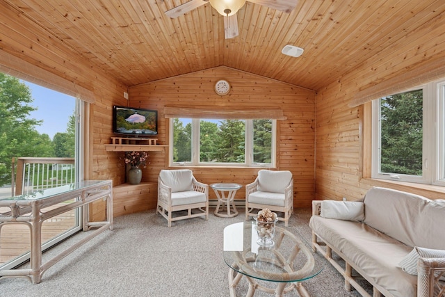 22087 Jasmine Way, Rogers, MN 55374 - living area with lofted ceiling, a ceiling fan, plenty of natural light, wood walls, and carpet flooring