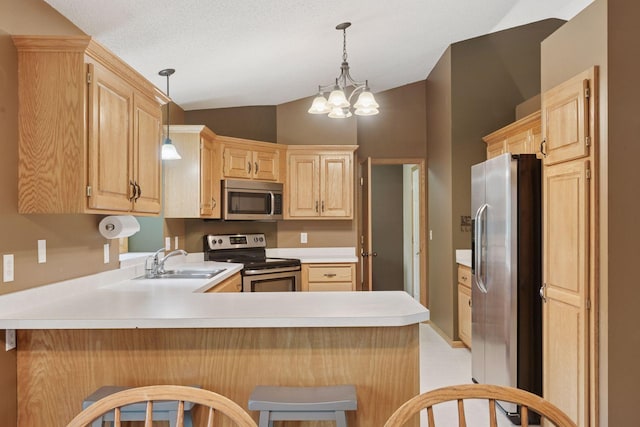 22087 Jasmine Way, Rogers, MN 55374 - kitchen with appliances with stainless steel finishes, a peninsula, vaulted ceiling, light brown cabinets, and light countertops