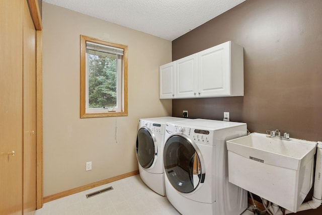 22087 Jasmine Way, Rogers, MN 55374 - laundry area with cabinet space, independent washer and dryer, a textured ceiling, and light floors