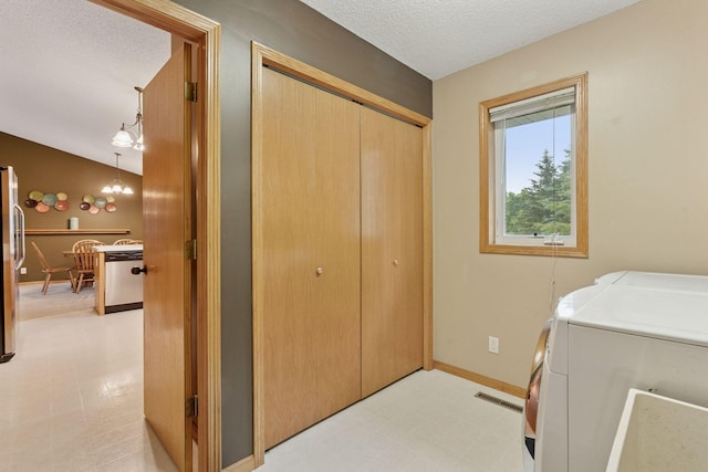 22087 Jasmine Way, Rogers, MN 55374 - laundry room with washing machine and dryer, light flooring, and a textured ceiling