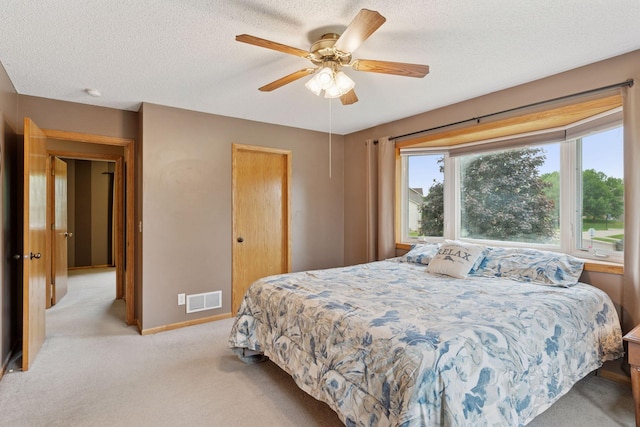22087 Jasmine Way, Rogers, MN 55374 - bedroom with light colored carpet, a ceiling fan, and a textured ceiling