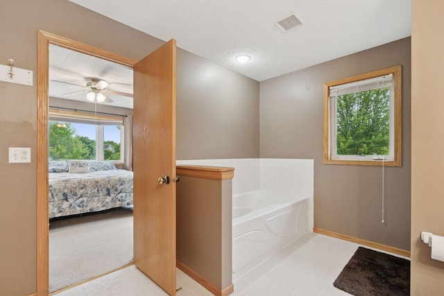 22087 Jasmine Way, Rogers, MN 55374 - bathroom with a textured ceiling, a bath, connected bathroom, and ceiling fan
