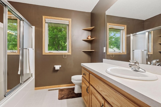 22087 Jasmine Way, Rogers, MN 55374 - bathroom with vanity, a textured ceiling, and combined bath / shower with glass door